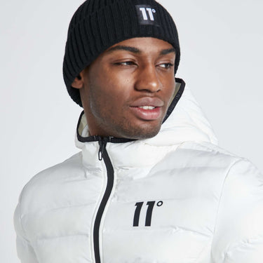 White hooded puffer jacket close-up with 11° logo and black-trimmed zipper
