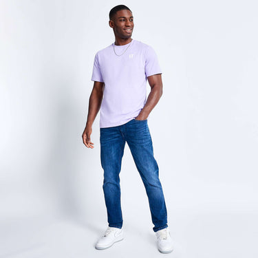 Light lavender crew-neck short-sleeve T-shirt worn with blue jeans