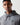 Charcoal marl pullover hoodie with drawstring hood and small chest logo, close-up
