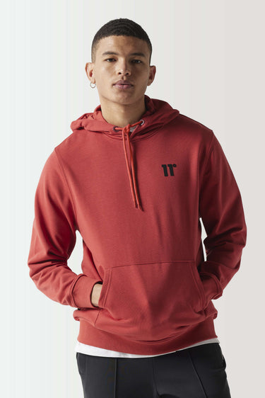 Red ochre pullover hoodie with black logo at chest and drawstring hood