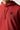Red ochre hoodie close-up with drawstring and black chest logo