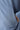 Light blue hoodie fabric close-up with stitched seam and pocket opening