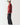 Red crewneck sweatshirt, side view with ribbed cuffs and small black chest logo