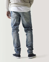 Mid-blue ripped jeans with knee rips and distressed wash