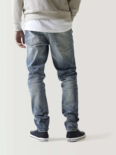 Mid-blue ripped jeans with knee rips and distressed wash