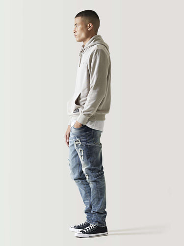Mid-blue ripped jeans with distressed thigh and knee patches
