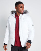 White padded jacket with fur-trimmed hood and front zipper, worn open at chest