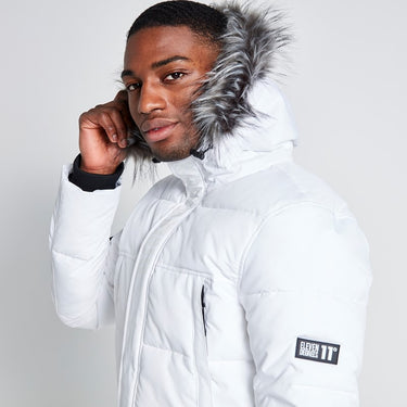 White padded jacket hood with gray fur trim and sleeve logo patch