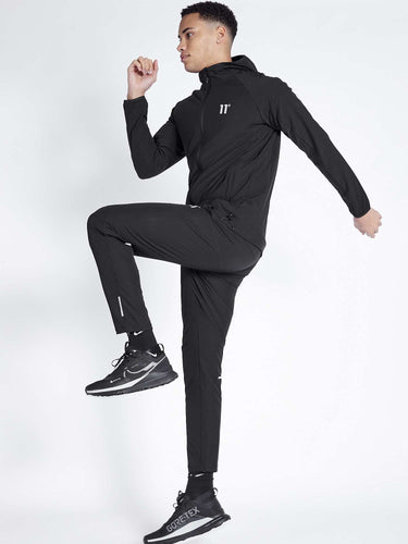 Men's black tech jacket with hood, front zip, and '11°' logo on chest
