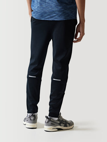 Black athletic pants with white knee stripe and ankle-cuff panels.