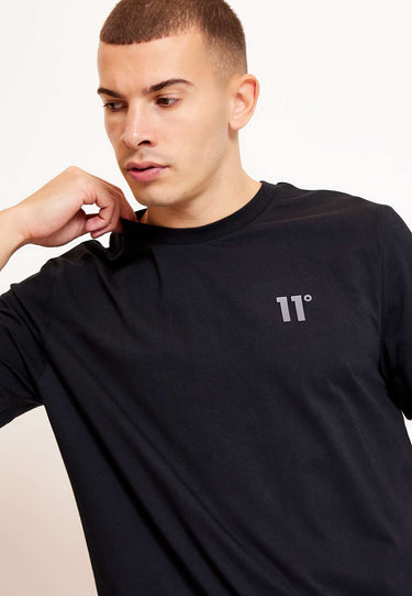 Black crew-neck t-shirt close-up of 3D embroidered '11°' logo