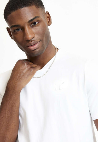 White crew-neck T-shirt with short sleeves and close-up of 3D chest embroidery
