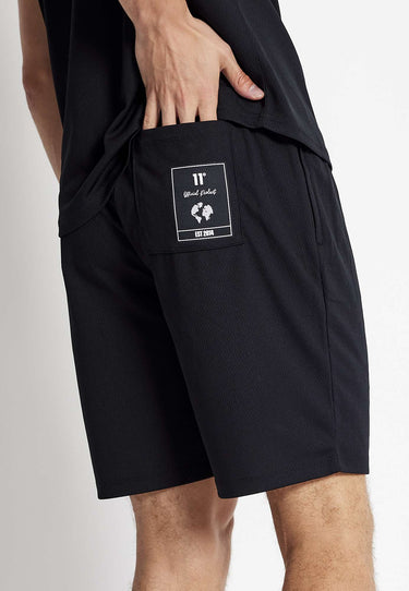 Black mesh shorts with small front logo patch and side seam pockets