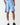 Light blue sweat shorts with black GREATEST logo tape on the side