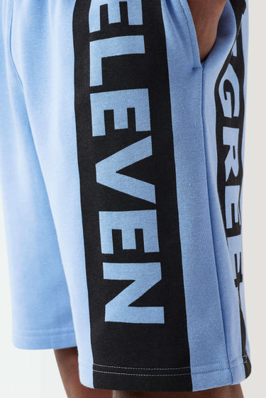 Light blue sweat shorts with close-up black ELEVEN logo side stripe