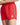 Red swim shorts close-up: elastic waistband and white stripe tape on side