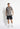 Black woven cargo shorts with belt loops, front cargo pocket, and small leg logo