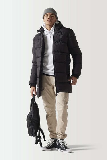 Longline puffer jacket in black with attached hood and front zipper
