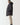 Black longline puffer jacket, side profile with quilted padding and hood