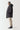 Black longline puffer jacket, side profile with quilted padding and hood