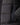 Black puffer jacket fabric close-up with vertical logo-embossed label