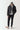 Black micro puffer jacket with hood up, front zipper, and small chest logo