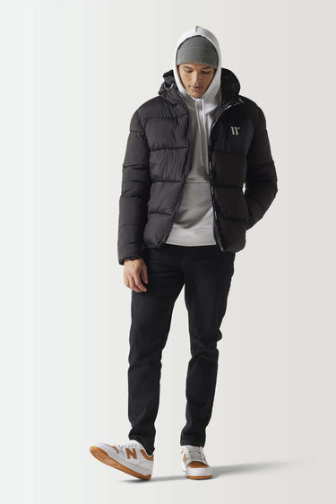 Black micro puffer jacket with hood up, front zipper, and small chest logo