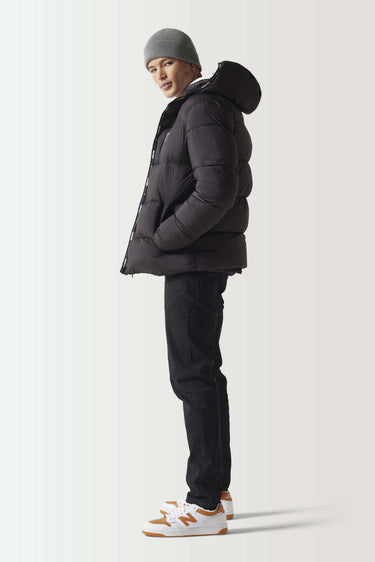 Black micro puffer jacket, side profile with hood and zip front