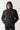Black micro puffer jacket with hood and ribbed inner lining, zip front
