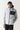 Micro puffer jacket with black chest panel, hood, full zip; gray and white quilting