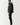Black panel puffer jacket shown from side with full-zip front and quilted insulation
