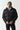 Black panel puffer jacket with full-zip front, standing collar, and chest logo
