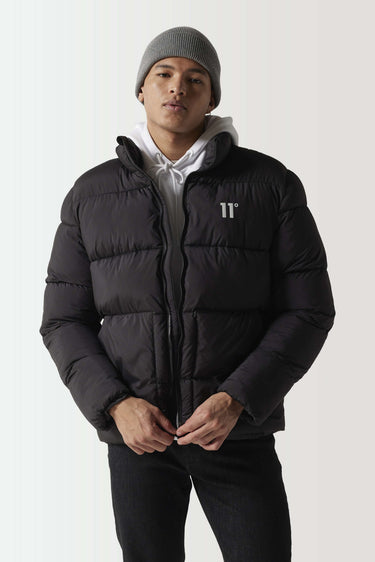 Black panel puffer jacket with full-zip front, standing collar, and chest logo