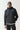 Black overhead hybrid jacket with hood and high collar, front zip, quilted chest