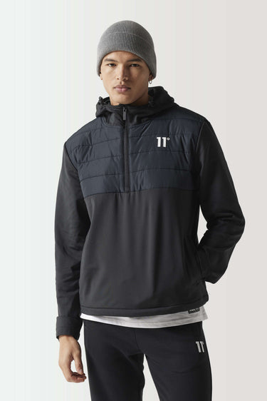 Black overhead hybrid jacket with hood and high collar, front zip, quilted chest