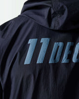 Navy jacket with large turquoise '11°' graphic on back panel