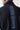 Navy full-zip sweat top close-up of vertical back logo text