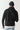 Black pullover hoodie with blue graphic print on back and adjustable hood.