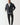 Black puffer jacket with zip front, hood, and taped sleeve details