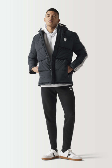 Black puffer jacket with zip front, hood, and taped sleeve details