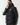 Black puffer jacket with zip front, hood, and 11° chest mark