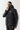 Black puffer jacket with zip front, hood, and 11° chest mark