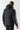 Black puffer jacket with hood and vertical taped sleeve stripe