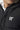 Black puffer jacket with front zipper and chest logo 11°