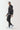 Black full-zip hoodie with hood and front zipper, side profile view