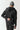 Black full-zip hoodie back view with hood and stitched seams