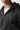 Black full-zip hoodie close-up at collar and chest with visible zipper