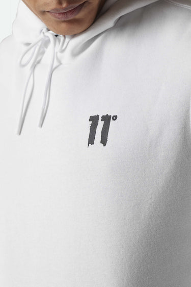White hoodie chest close-up with bold black '11°' logo print
