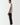 Black track pants, side profile with elastic waistband and tapered legs