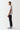 Black track pants, side profile with elastic waistband and tapered legs